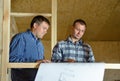 Two builders discussing a building plan Royalty Free Stock Photo