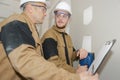 two builders in helmets working with electricity indoors Royalty Free Stock Photo
