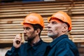 two builders in helmets working with walkie talkie outside Royalty Free Stock Photo