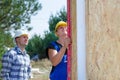 Two builders installing insulated wall panels Royalty Free Stock Photo