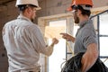 Two builders look at the drawing of the object Royalty Free Stock Photo