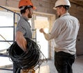 Two builders look at the drawing of the object Royalty Free Stock Photo