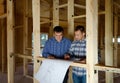 Two builders in a new build house Royalty Free Stock Photo