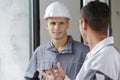 Two builders talking indoors Royalty Free Stock Photo