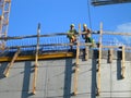 Two builders. Workers on top of a constructed building