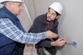 Two builders working with electricity indoors Royalty Free Stock Photo