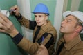 Two builders working with electricity indoors Royalty Free Stock Photo