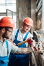 Two builders working together on a brick wall Royalty Free Stock Photo