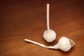 Two bulbs of garlic on a wooden table. Royalty Free Stock Photo