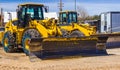 Two Bulldozers With Snow Tires In Springtime