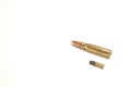 Two bullets, one small and one large. The one below is a .22 soft hollow point, the one above a 7.62 x 51mm NATO. Royalty Free Stock Photo