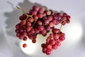 Two Bunches of fresh wine pink grapes falling on a white background big size high resolution Royalty Free Stock Photo