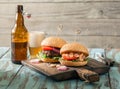 Two burger with shrimp and beef patty and light beer Royalty Free Stock Photo