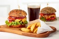 Two burgers with chips and glass of cola Royalty Free Stock Photo