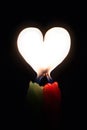 Two burning candles with a flame in the form of a heart on a black background Royalty Free Stock Photo