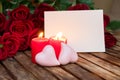 Two burning candles with fresh roses Royalty Free Stock Photo