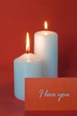 Two burning candles on a red background Royalty Free Stock Photo