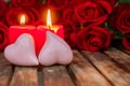 Two burning candles with fresh roses Royalty Free Stock Photo