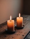 Two Burning Candles on a Wooden Table in Warm Light. Royalty Free Stock Photo
