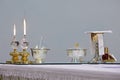 two burning church candles and ostensory on the table