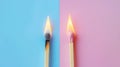 Two burning matches on split pastel blue and pink background, ideas, emotional burnout, teamwork. Generative AI Royalty Free Stock Photo
