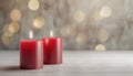 Two red candles in romantic defocused lights neutral background