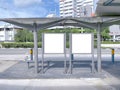 Two bus stop blank advertising mock ups at empty bus stop shelter by main road. Out-of-home OOH classifieds billboard Royalty Free Stock Photo