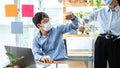 Two business colleagues greet each other by bumping elbows when meeting in office while wearing face mask Royalty Free Stock Photo