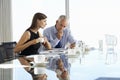 Two Business Colleagues Sitting Around Boardroom Table Having In Royalty Free Stock Photo