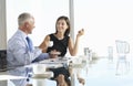 Two Business Colleagues Sitting Around Boardroom Table Having In Royalty Free Stock Photo