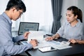 Two business colleagues using calculator to checking financial report with chart document and brainstorm Royalty Free Stock Photo