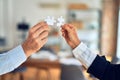 Two business hands trying to connect couple puzzle piece at office Royalty Free Stock Photo