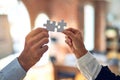 Two business hands trying to connect couple puzzle piece at office Royalty Free Stock Photo