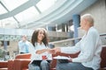two business ladies shaking hands sitting in the lobby of the business center. Royalty Free Stock Photo