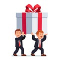 Two business man carrying huge holiday gift box