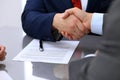 Two business man shaking hands to each other above signed contract Royalty Free Stock Photo