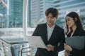 Two business man and women standing meeting by using laptop for project Royalty Free Stock Photo