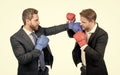 two business men in boxing gloves punching for leadership isolated on white, business fight