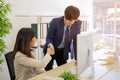 Two business men and business women shake hands in the office meeting with a smiling face Royalty Free Stock Photo