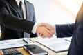 Two business men partners shaking hands during a meeting to deal Royalty Free Stock Photo