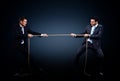 Two business men pulling rope in a competition Royalty Free Stock Photo