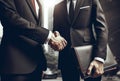 Two business men shaking hands, finishing up meeting. Successful businessmen handshaking after good deal. Royalty Free Stock Photo