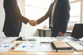 Two business men shaking hands during a meeting to sign agreement and become a business partner, enterprises, companies, confident Royalty Free Stock Photo