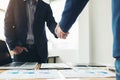 Two business men shaking hands during a meeting to sign agreement and become a business partner, enterprises, companies, confident Royalty Free Stock Photo