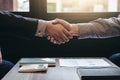 Two business men shaking hands during a meeting to sign agreement and become a business Royalty Free Stock Photo