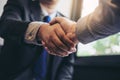 Two business men shaking hands during a meeting to sign agreement and become a business Royalty Free Stock Photo