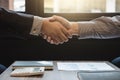 Two business men shaking hands during a meeting to sign agreement and become a business Royalty Free Stock Photo