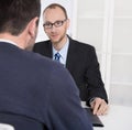 Two business men sitting in the office: meeting or job interview Royalty Free Stock Photo