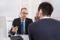 Two business men sitting in the office: meeting or job interview Royalty Free Stock Photo