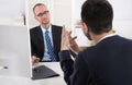 Two business men sitting in the office: meeting or job interview Royalty Free Stock Photo